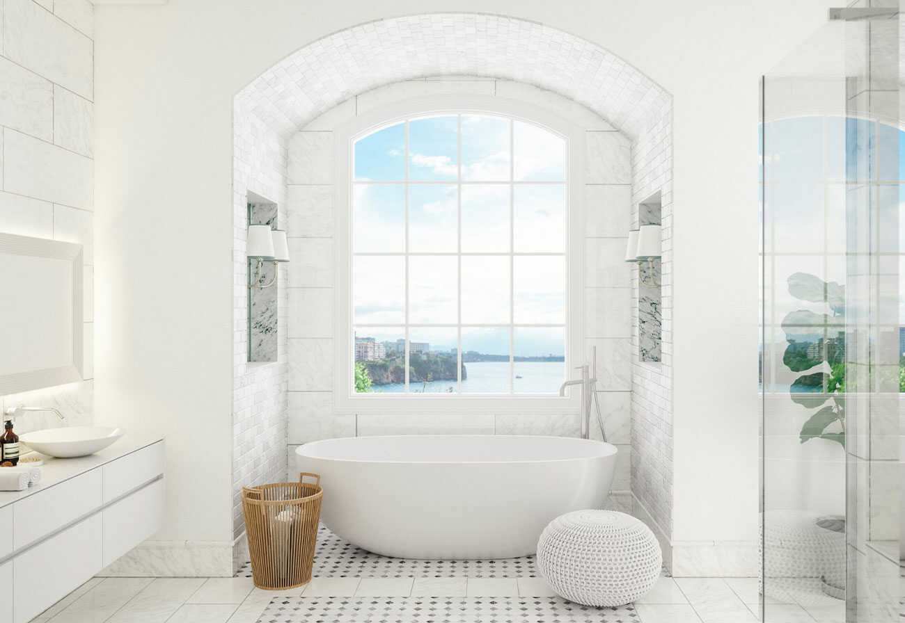 Glamorous white bathroom with arched walls and a freestanding bathtub.
