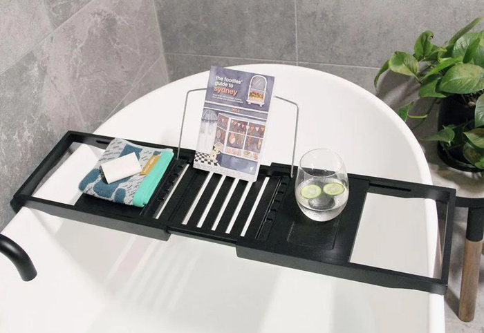 Butlers Black Bath Tray with a glass of water on top.