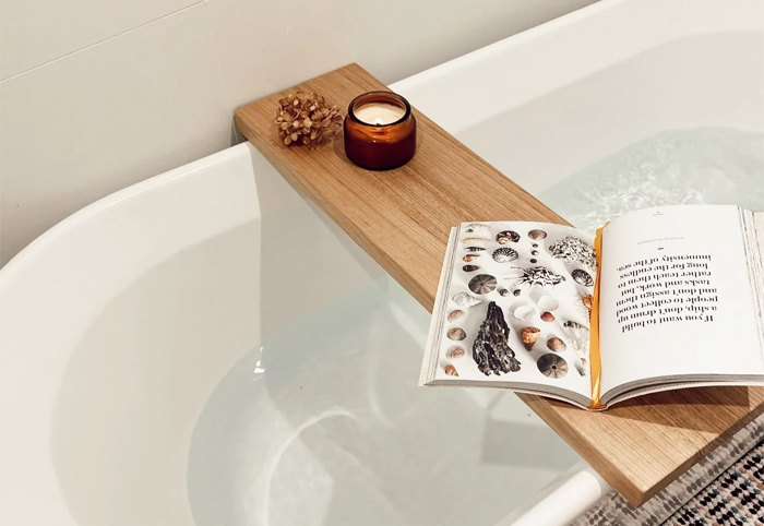 The Timberline Bath Caddy 2.0 shown with a book and candle.