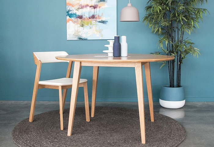 Scandi-style dining table in light wood with a matching chair.