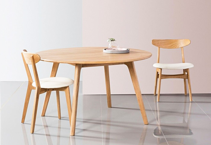 Minimalist round table with two matching chairs.