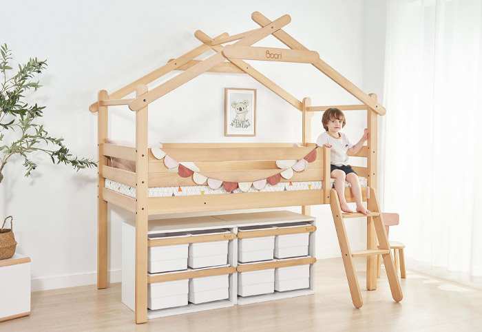 Child sitting on the Boori Forest Teepee Loft Bed.