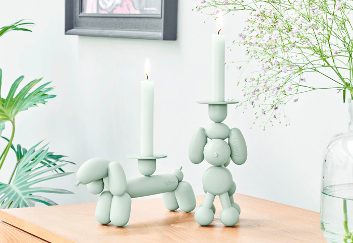 Fatboy Can Dog candle holders on a wooden bench.