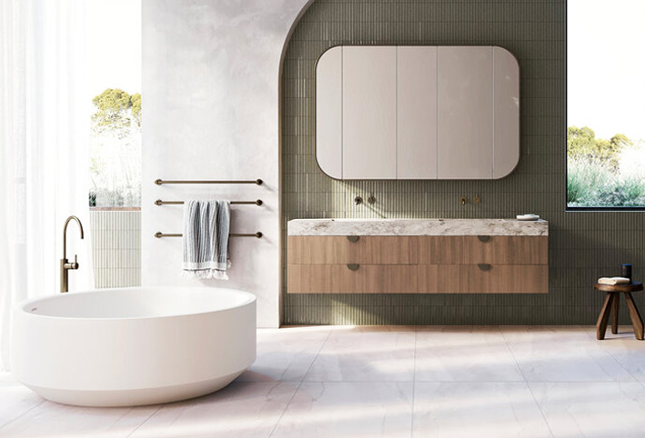 Contemporary bathroom with round tub and curved mirror.