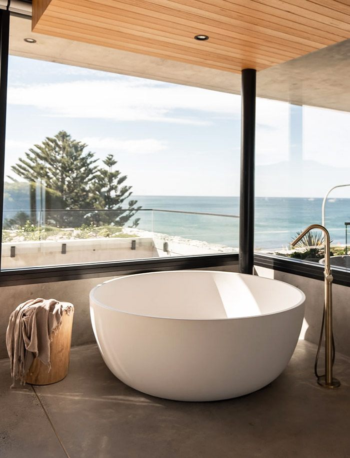 Round bath with an ocean view.