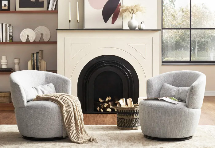 Two grey Castlery Amber Swivel Chairs next to a fireplace.