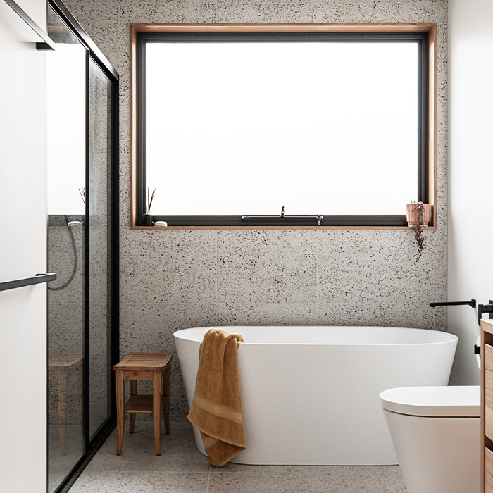 Bathroom featuring a modern bath tub below a large window.