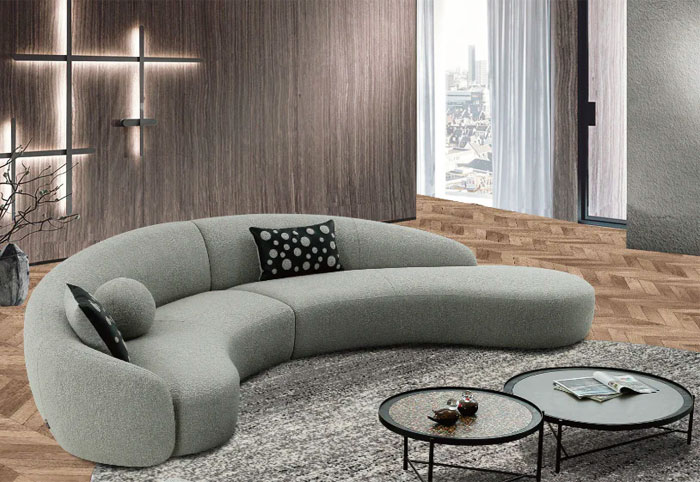 Mars curved lounge suit in grey shown in a modern living room.
