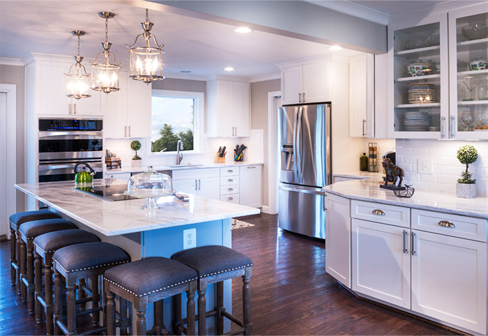 A white Hamptons kitchen with modern stainless steel appliances.