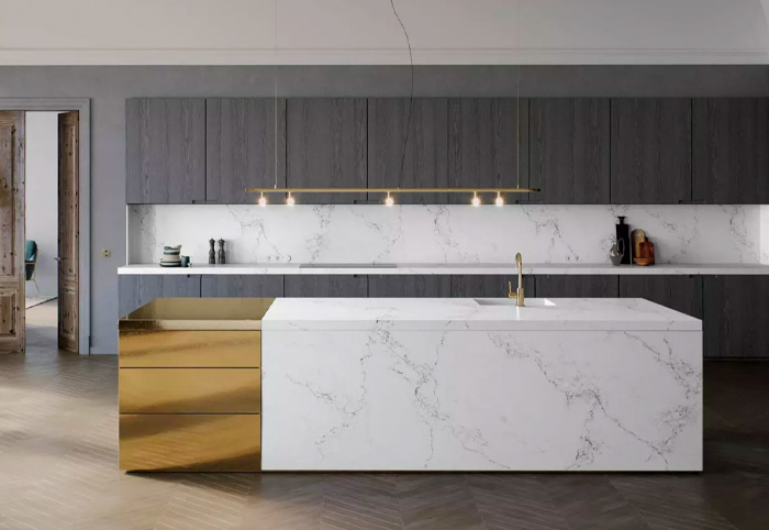 Modern kitchen with dark grey cabinets and white stone bench.