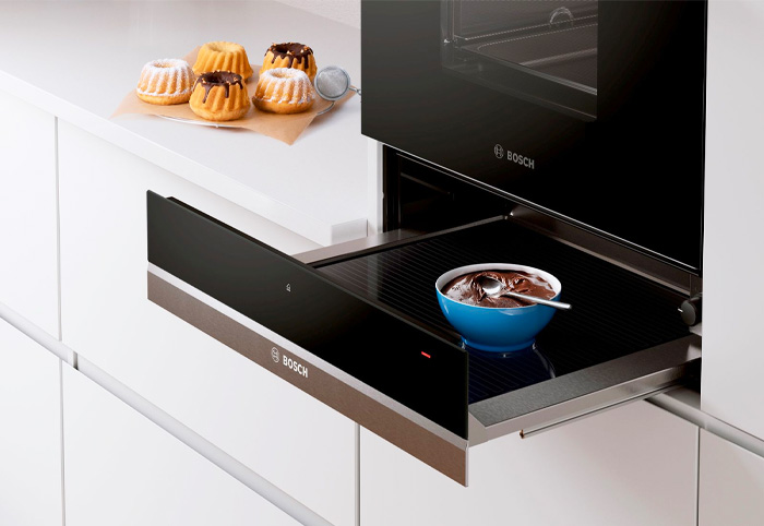 Bosch warming cabinet shown in with a bowl of chocolate sauce inside.
