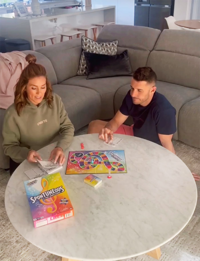 Georgia Love plays a board game with Lee Elliot.
