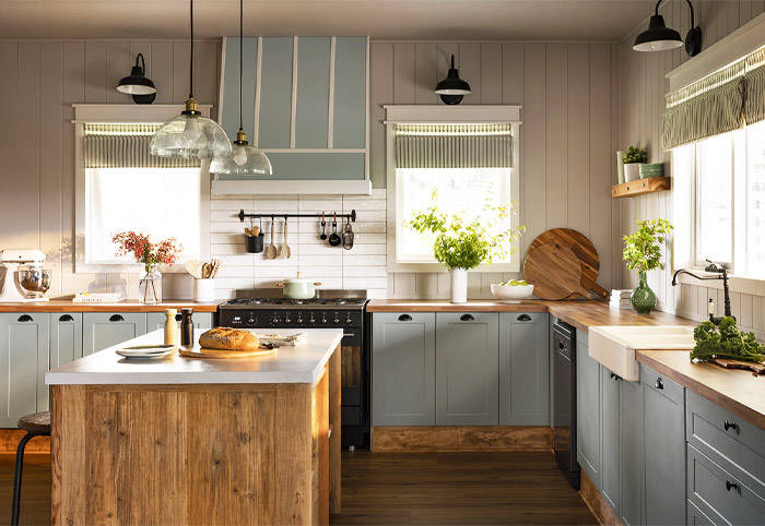 Farmhouse kitchen with blue cabinets and timber benchtop.