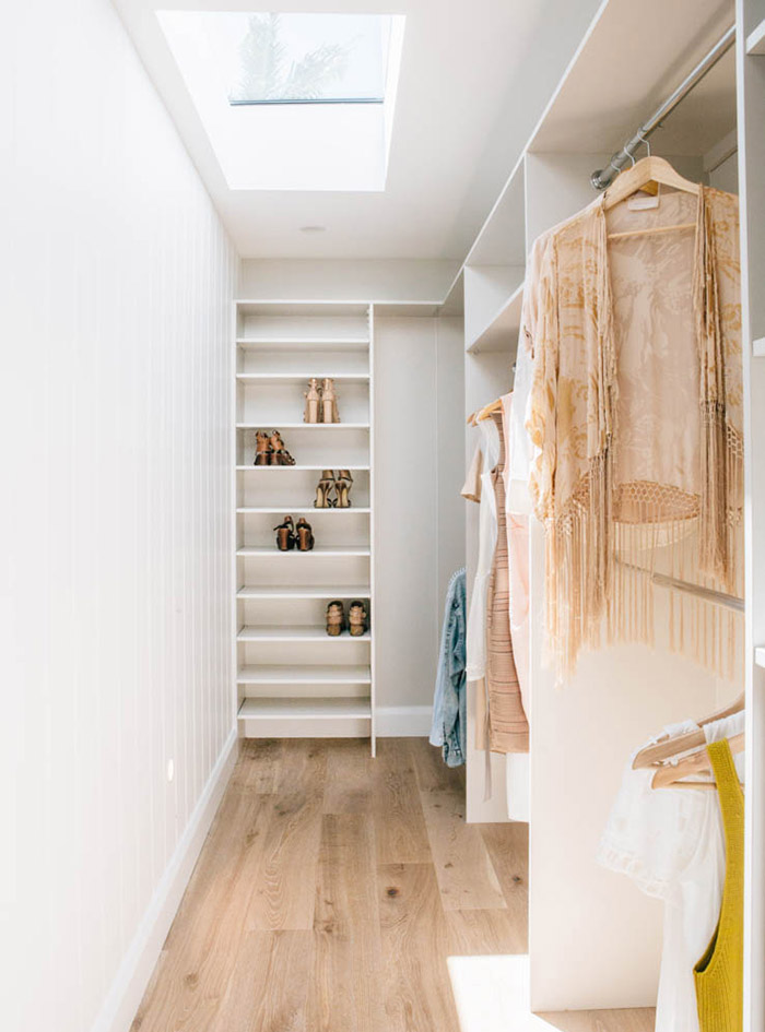 A light and bright walk-in wardrobe with overhead skylight. 