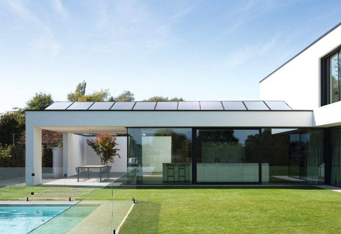 Modern house with solar panels on part of the roof.
