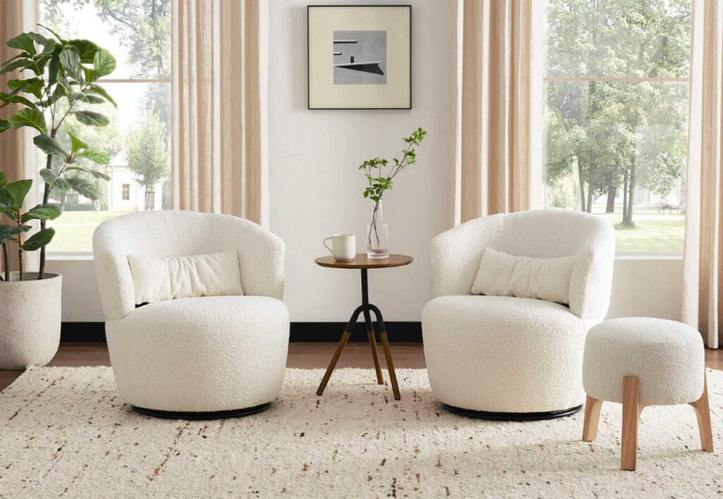 Two Castlery Amber Boucle Swivel Chairs pictured with a brown side table.