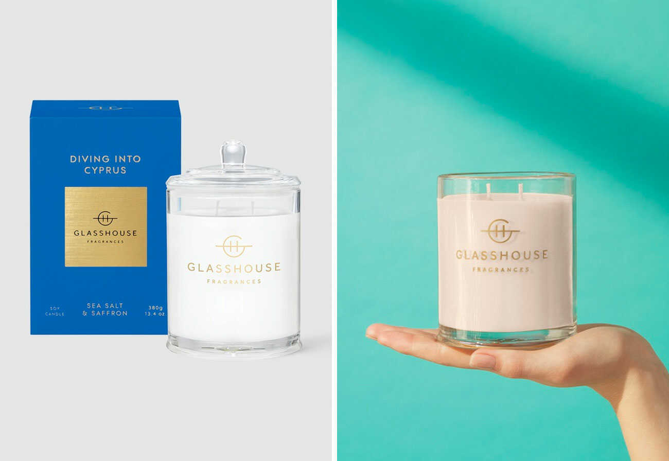 A glasshouse candle in its packaging and shown in a woman's hand.