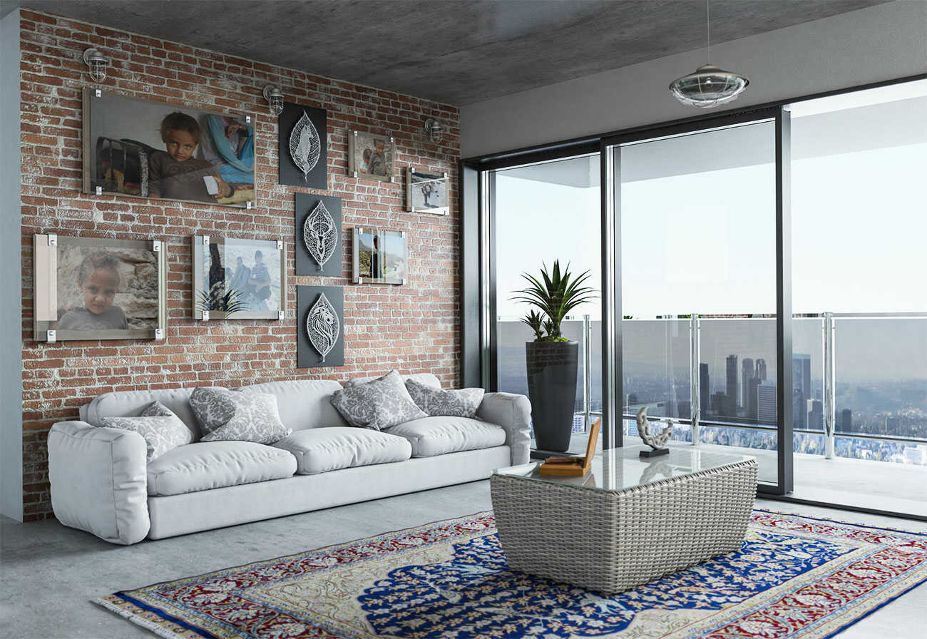 Urban apartment living room with an exposed brick wall covered in art.