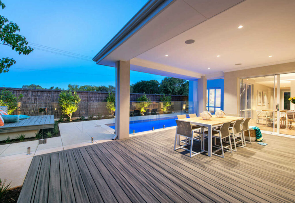 Patio of a modern home featuring swimming pool and deck.
