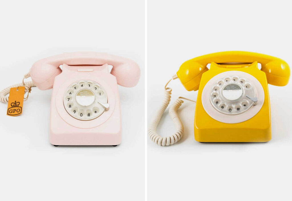 Vintage rotary phones in pink and yellow.