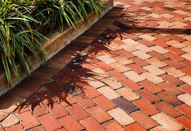 Red-brick paving with concrete edging.
