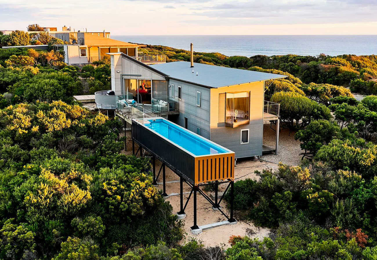 An elevated shipping container pool at a beach house in Victoria.