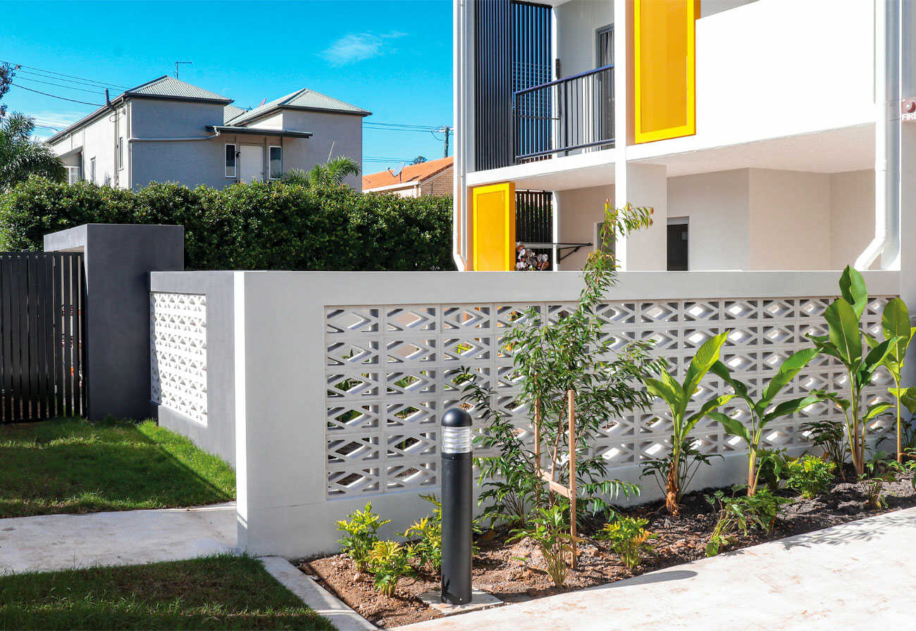 Exterior of a modern Australian townhouse with a fence made of breeze bricks.