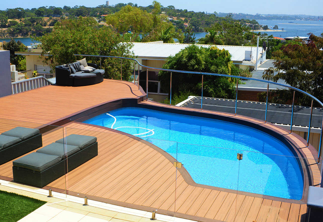 Abstract-shaped above-ground swimming pool with a timber deck.