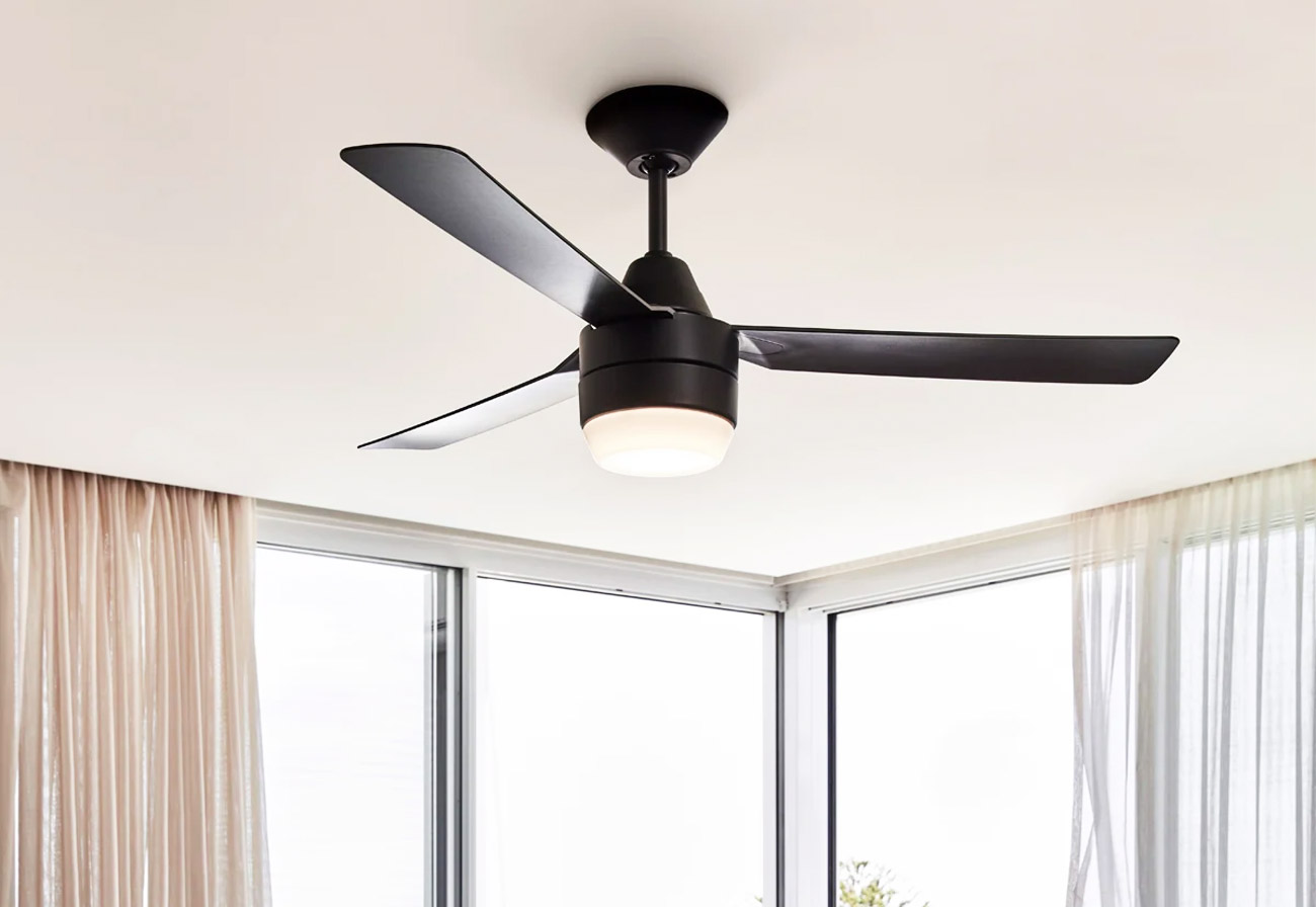 A black ceiling fan in a bedroom.