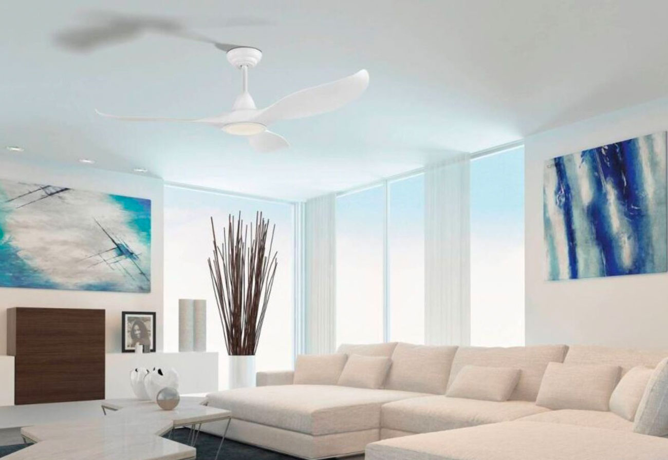 A modern white ceiling fan hangs from a living room ceiling.