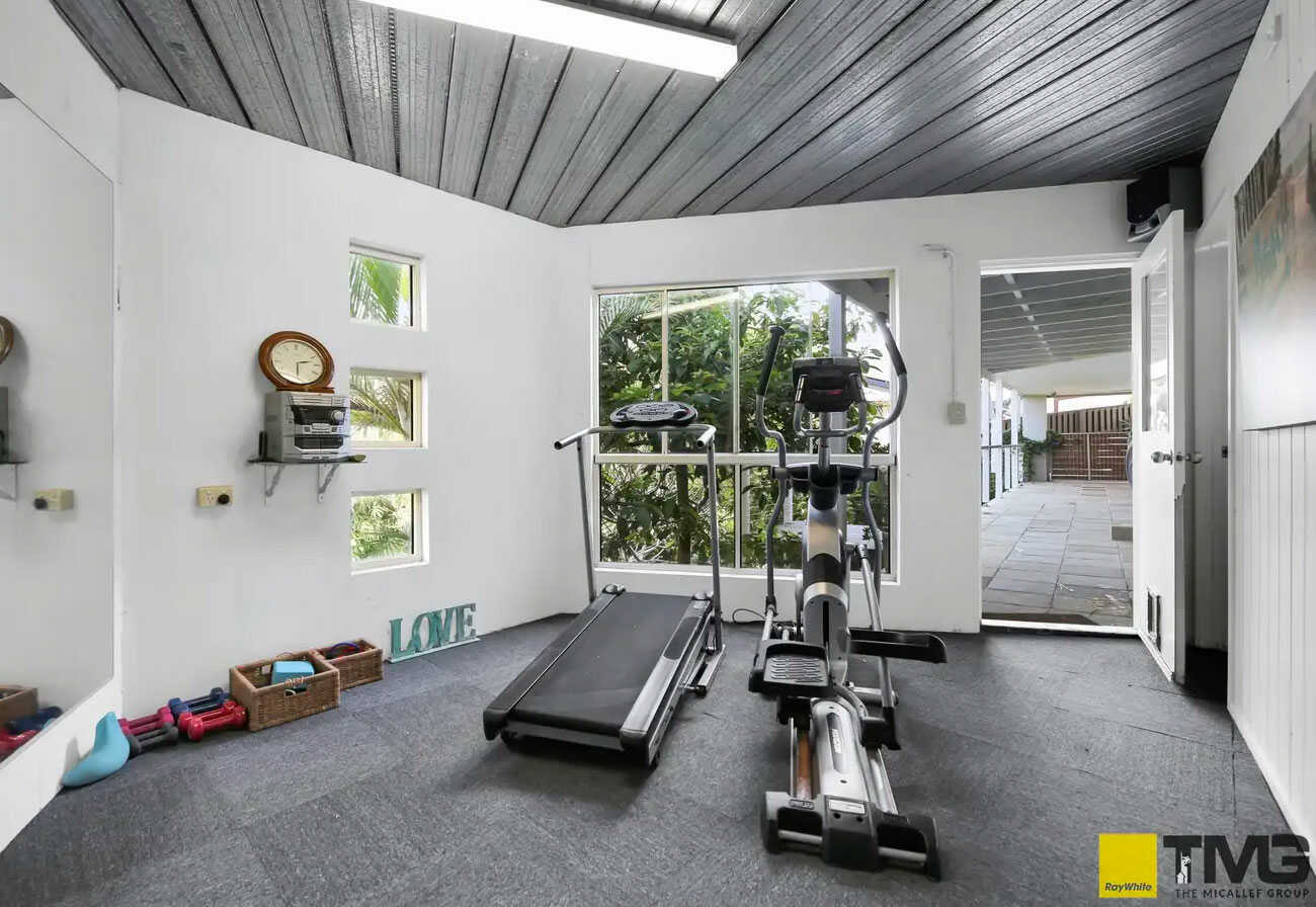 A home gym with elliptical bike and treadmill.