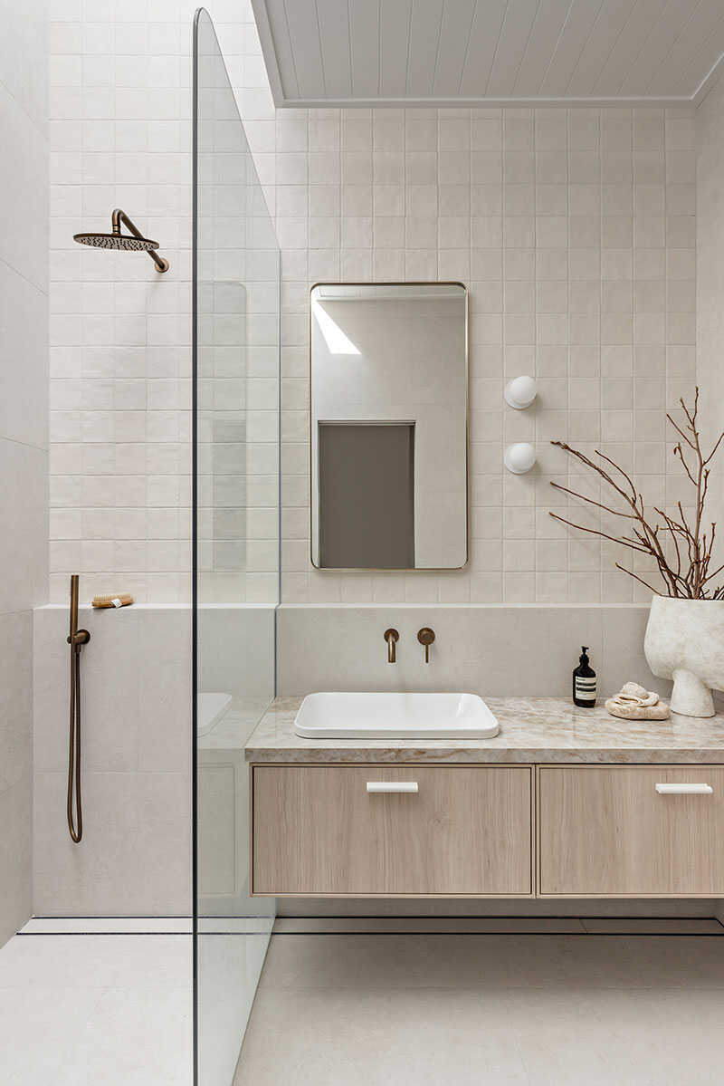 Modern Australian bathroom with wooden vanity and statement taps.