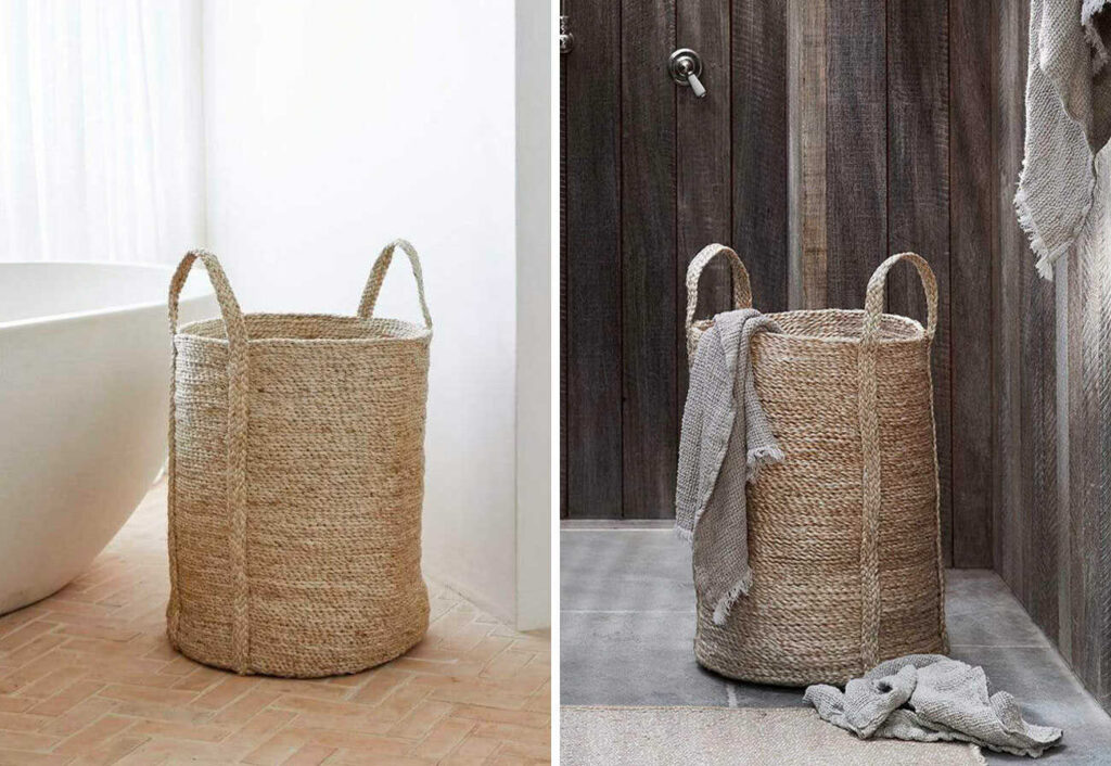 A jute laundry hamper shown next to a bath and against an outdoor wall.