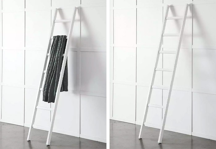 White decorative ladder leaning against an interior wall.