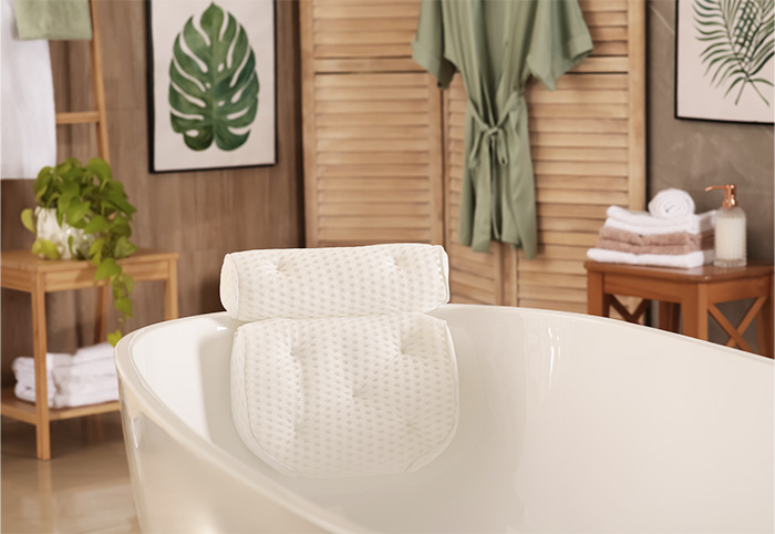Bathtub with a padded support attached for the head and neck.