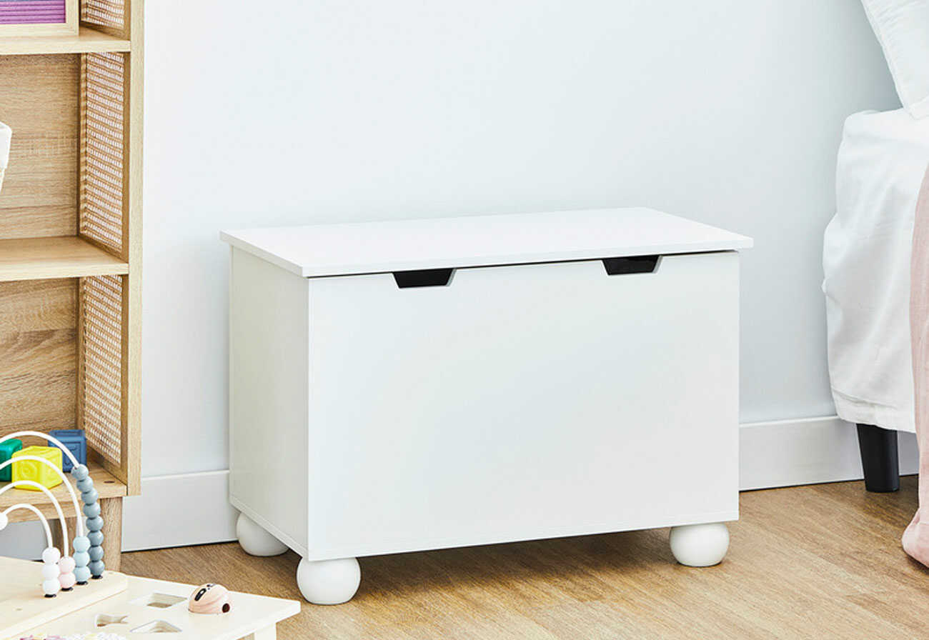 White wooden toy box in a kids' room.