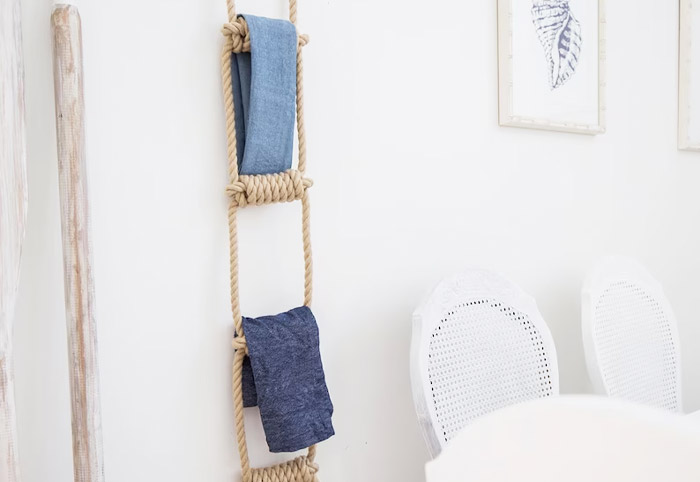 Rope ladder holding napkins hanging against a wall.
