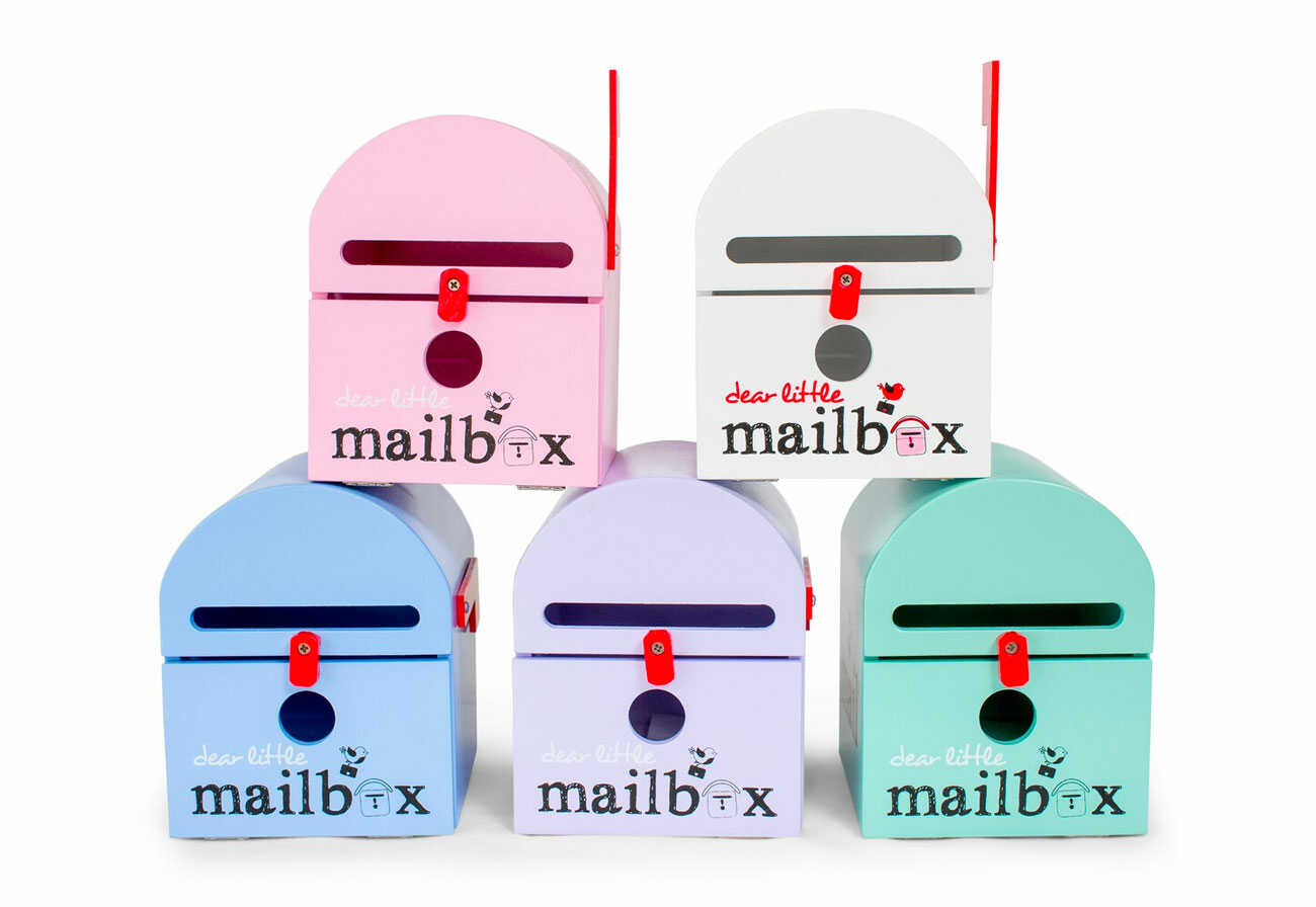 Five personalised kids' letterboxes in different colours.