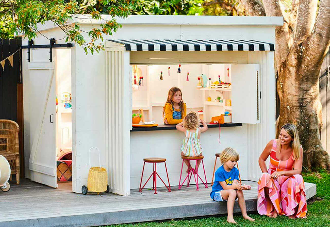 Children and mother play in the white Mister Zimi Cubby House.
