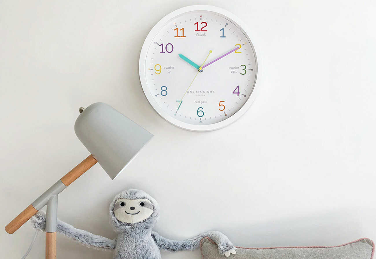 Kids' learning clock hanging on a wall.
