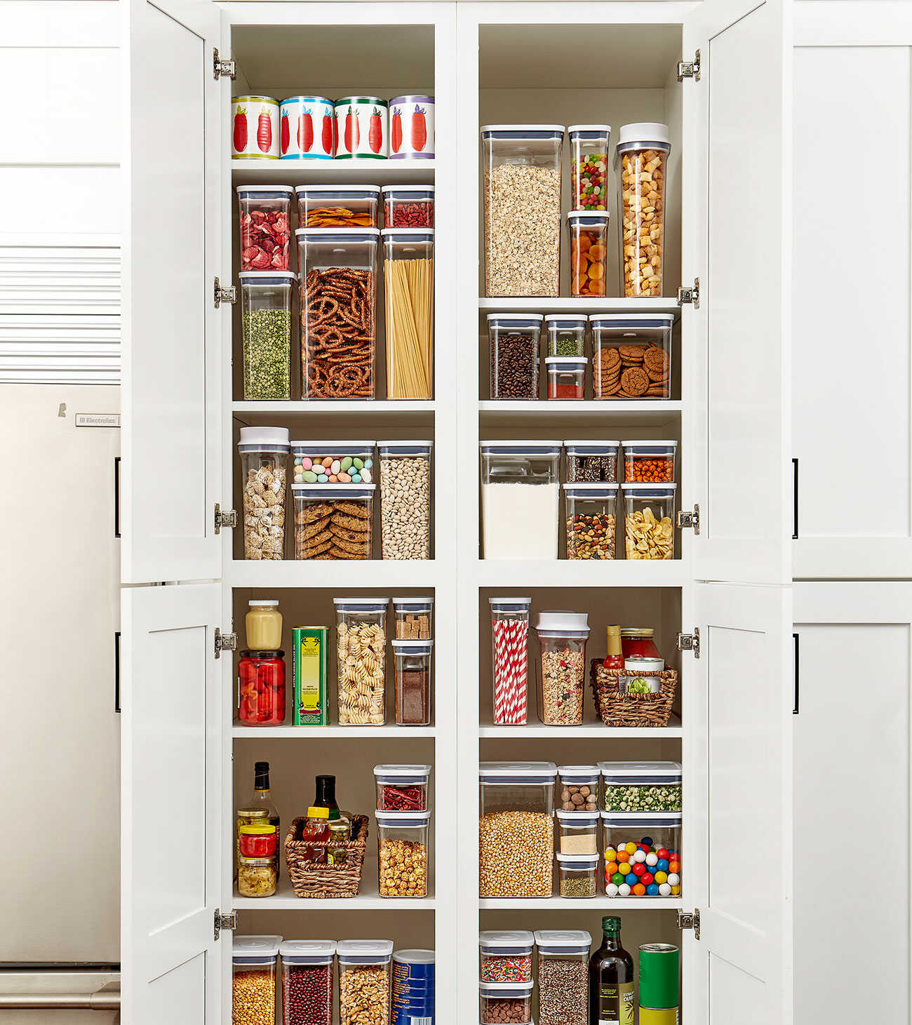 An open pantry organised using storage containers.