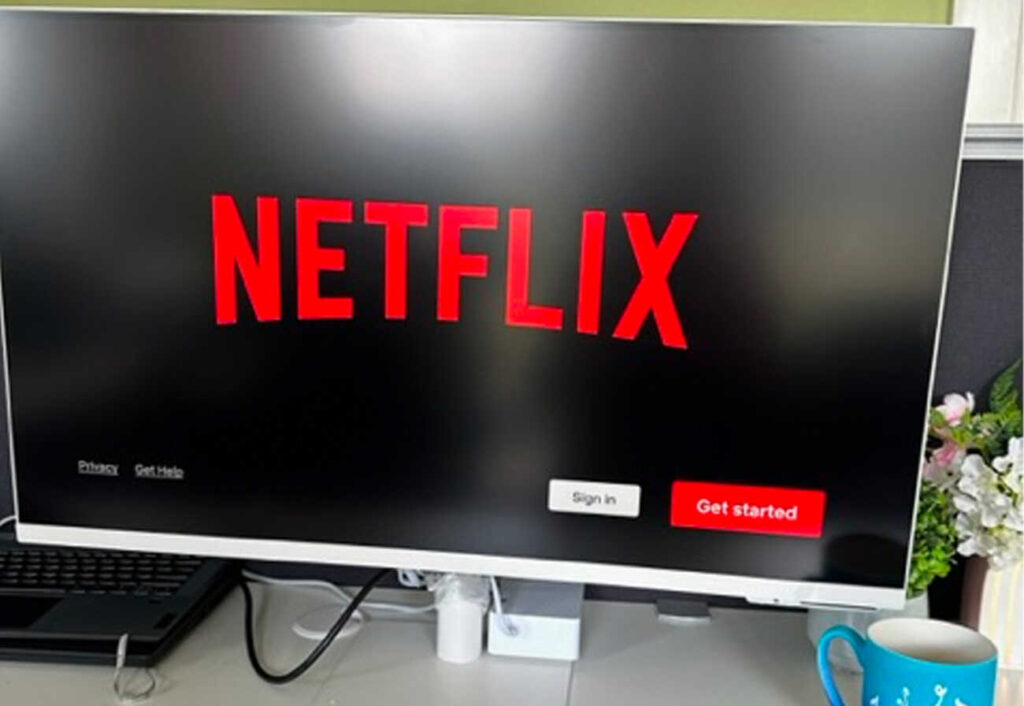 Netflix welcome screen showing on a large external monitor.