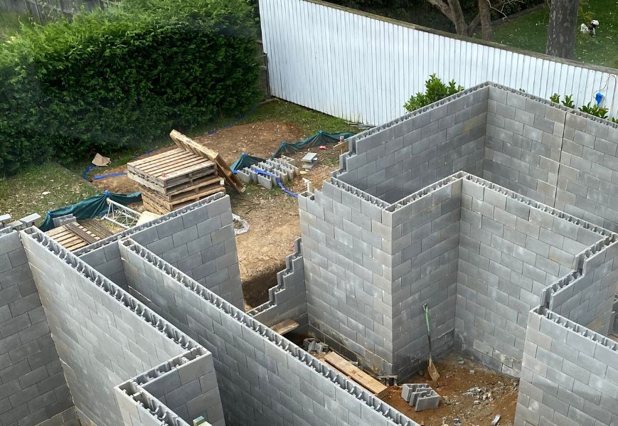 Swimming pool walls in construction using Versaloc concrete blocks.