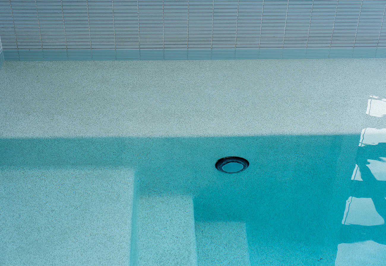 The beadcrete surface of a modern swimming pool. 