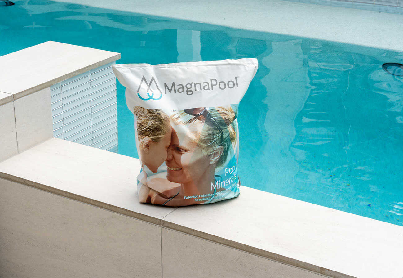 A bag of MagnaPool minerals sitting on the edge of a pool.