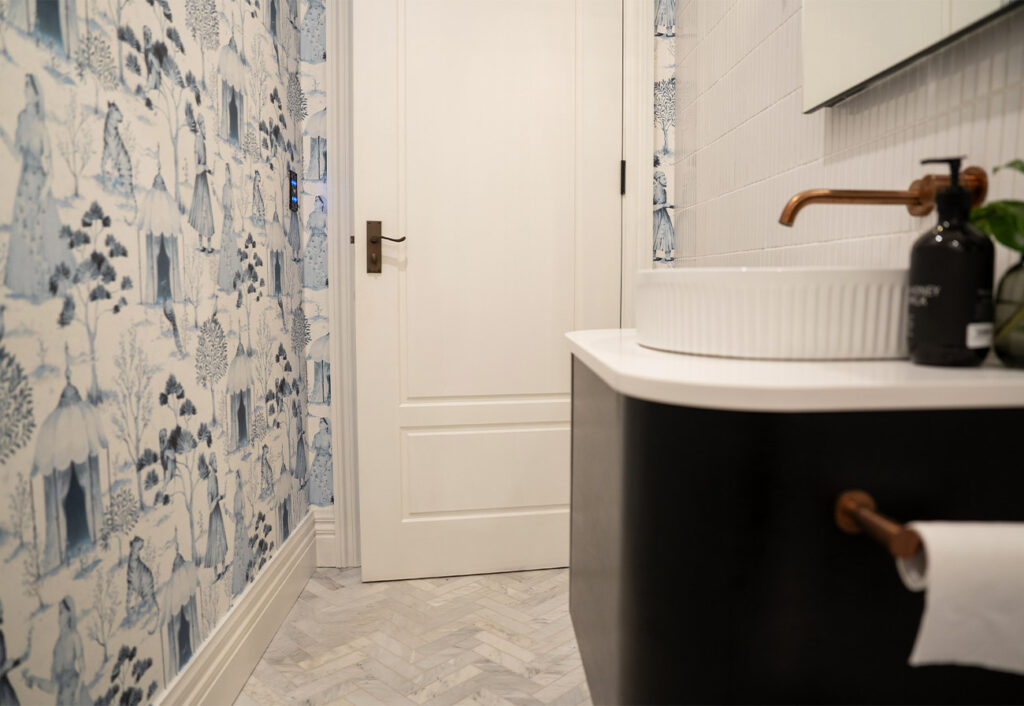 Making HOME guest bathroom with feature blue patterned wallpaper and Hume doors.