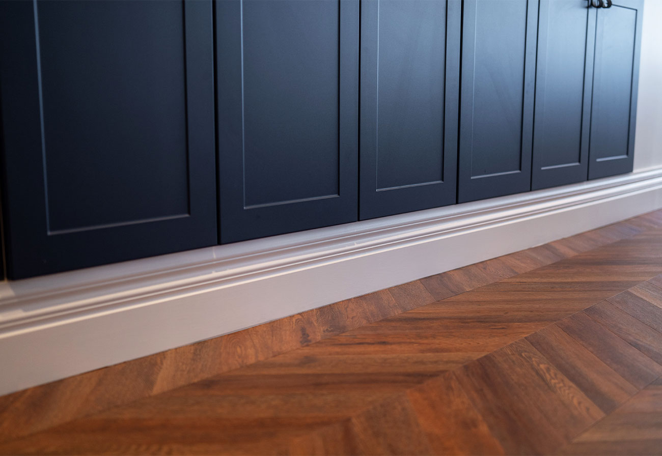 Skirting boards under a sideboard.