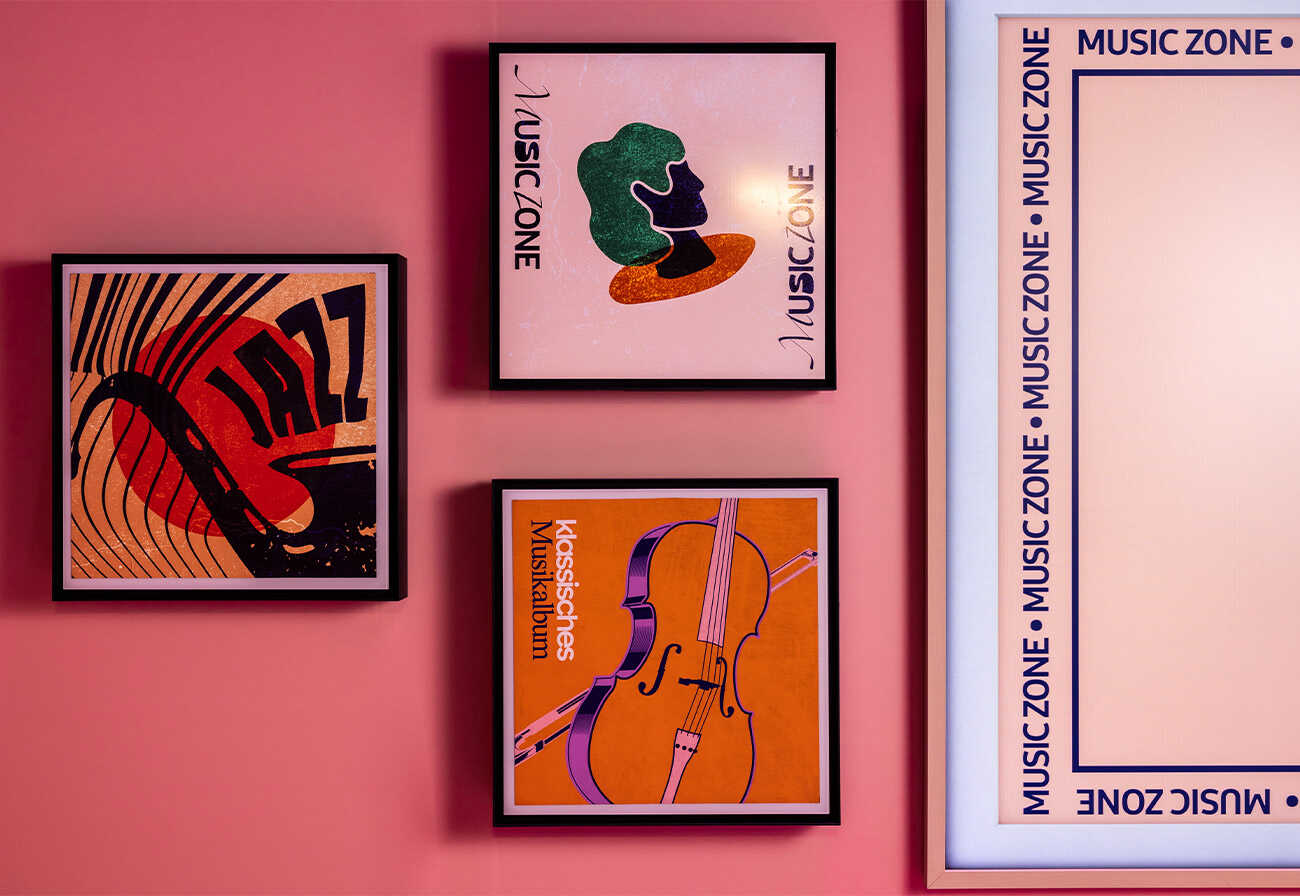 Samsung Music Frames mounted on a pink wall.