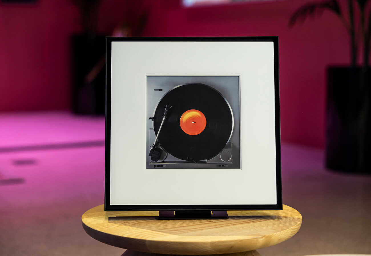 Samsung Music Frame on a small round table.