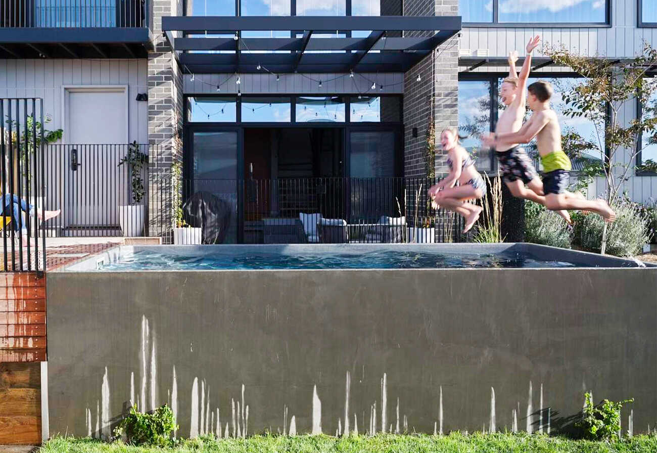 Children jumping into a plunge pool.
